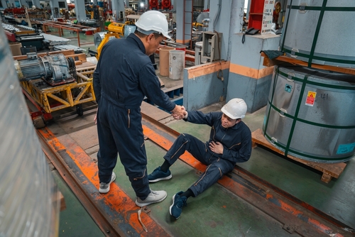 In Need of Workers Compensation Lawyer in Las Vegas Nevada Worker helping up a co-worker after an injury at work