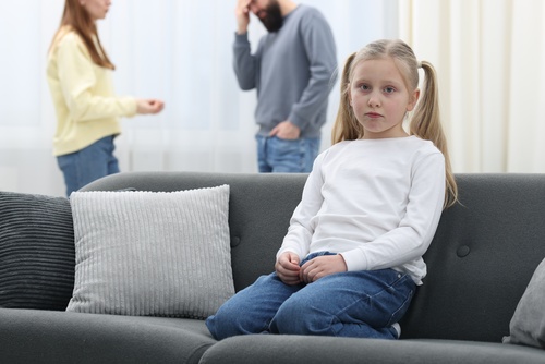 Sad Child Sitting on Couch During Unmarried Parents Dispute Austin