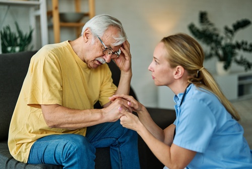 Roanoke Nurse Comforting Distressed Elderly Nursing Home Patient