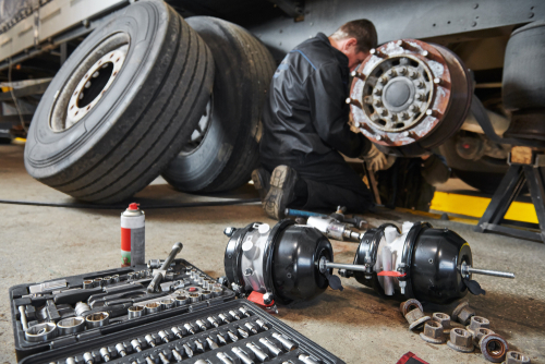 Mechanic Inspecting Semi-Truck Brake System in Provo Utah