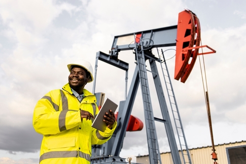 Texas Oil Field Worker Standing Near Pump Jack