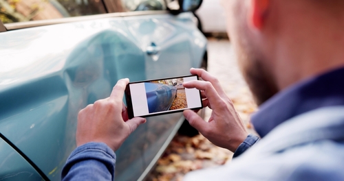 Florida Driver Photographing Car Crash Damage for Insurance