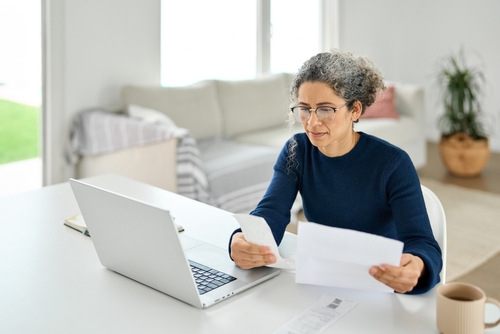Woman Reviewing Medical Bills After Indianapolis Grocery Store Fall woman reviewing medical bills after indianapolis grocery store fall