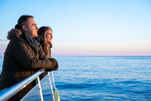 Couple Leaning on Cruise Ship Railing at Sea