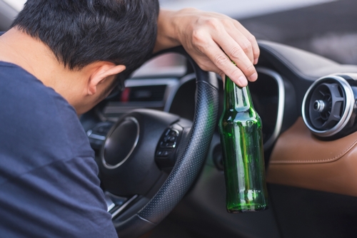 Drunk Driver Holding Beer Bottle While Driving in South Carolina