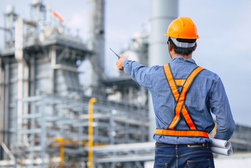 Construction worker pointing to construction site