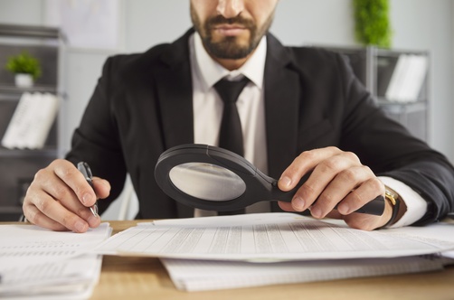 Miami Consumer Fraud Investigator Reviewing Documents With Magnifying Glass What Is a Consumer Fraud Class Action in Miami?