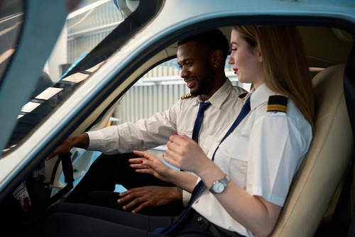 Student Pilots Training in Small Aircraft Cockpit