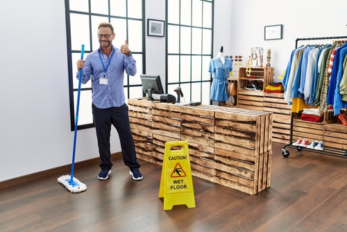 North Charleston Store Employee Mopping With Wet Floor Sign