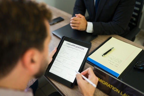 Client Meeting Immigration Lawyer Completing Visa Application