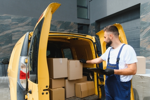Philadelphia Delivery Driver Checking Packages in Van