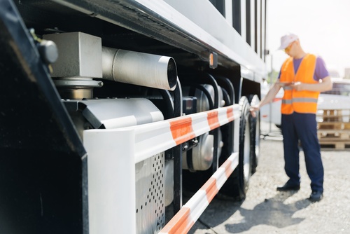 Florida Worker Inspecting Commercial Truck Safety Systems