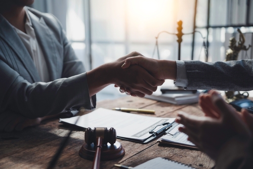 Houston Hail Claim Lawyers Shaking Hands After Settlement