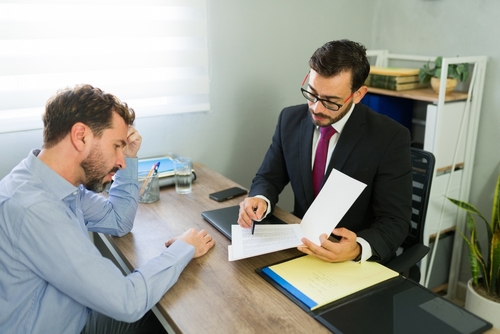 Reno Workers Compensation Attorney Consulting Client Man talking to his lawyer discussing workers' comp