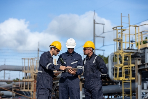 Houston Oil Workers in Safety Gear at Petroleum Facility