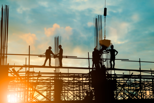 Construction workers working on platforms
