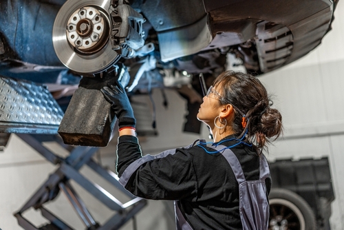 Female Mechanic Inspecting Defective Vehicle Los Angeles