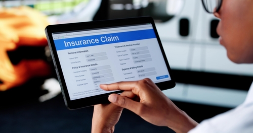 Woman Inspecting Hit-and-Run Car Damage Roanoke Virginia Person using tablet displaying Insurance Claim form with vehicle visible in background