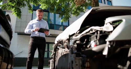 Insurance Agent Inspecting Damaged Car After Tucson Accident