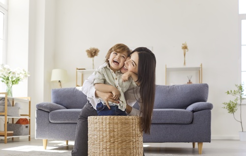 Mother and Child at Home Las Vegas Custody Case Mother lifting smiling child indoors during playful family moment