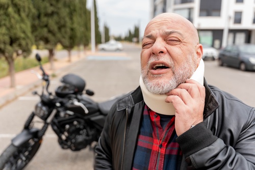 Man clutching lower back while standing, depicting visible severe back pain