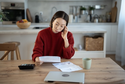Stressed Woman Reviewing Finances During Bank Garnishment Worcester MA Stressed Woman Reviewing Finances During Bank Garnishment Worcester MA
