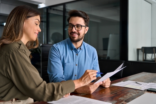 Newton Square Pennsylvania Securities Class Action Lawyer Woman and man reviewing documents together at office conference table