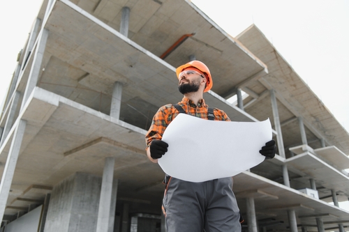 Reno Construction Worker With Hard Hat at Building Site Reno Construction Worker With Hard Hat at Building Site