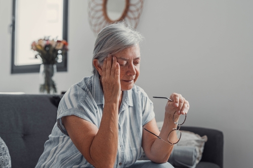 Elderly Woman Showing Nursing Home Neglect Signs Roanoke Elderly woman sitting on sofa holding framed photo and album