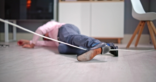 Person Tripping Over Wire Cord Fall Injury Florida person lying on floor after tripping over electrical wire cord