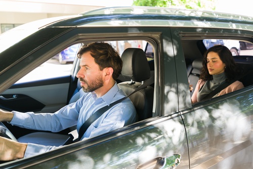 Charlotte NC Lyft Driver Transporting Female Passenger male rideshare driver operating vehicle with female passenger seated in back