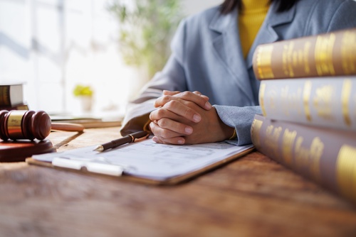 Philadelphia Commercial Auto Negligence Lawyer Consultation attorney seated at desk with gavel, legal books, and clipboard