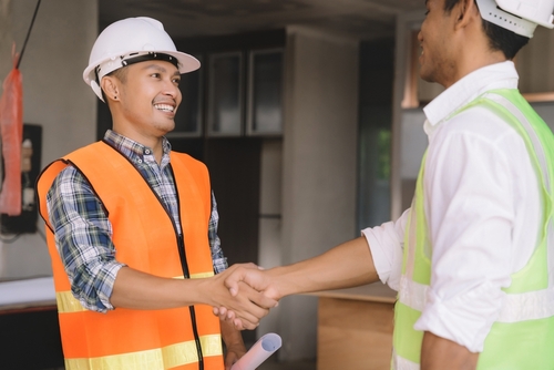 Construction workers shaking hands
