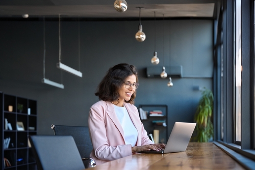 Woman on her laptop researching about vocational rehab benefits she can get through workers' comp